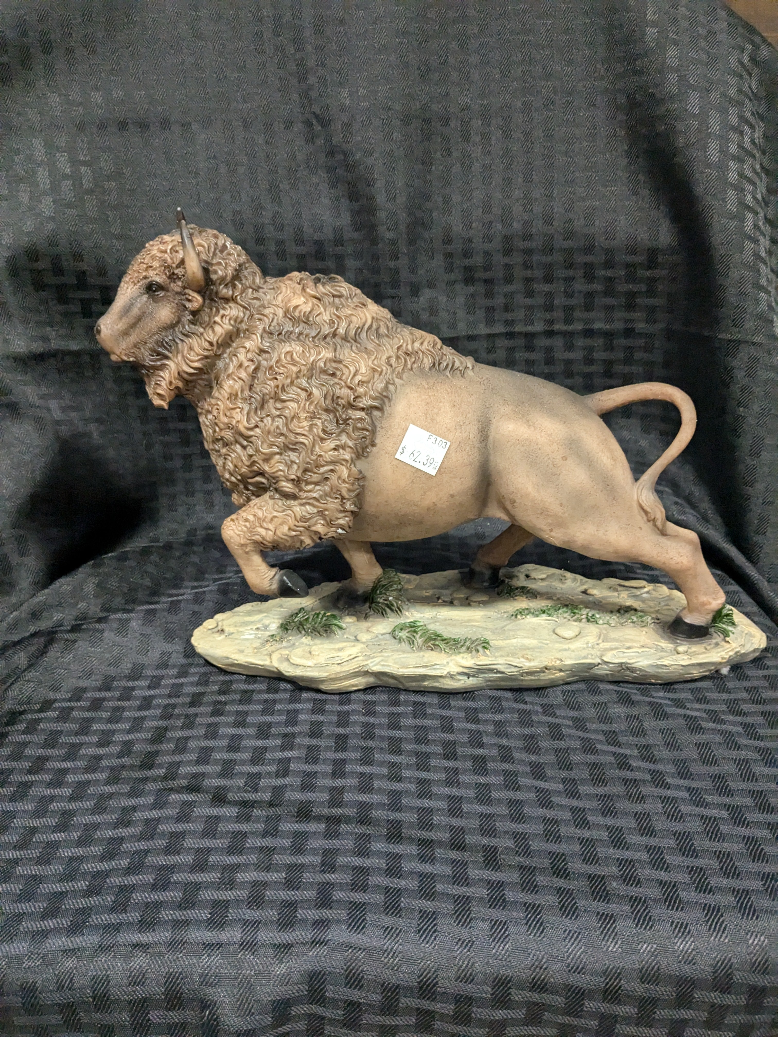 Buffalo Charge Statue – A stunning sculpture depicting a powerful buffalo in mid-charge, perfect for adding a dynamic touch to home or office decor. Crafted from high-quality materials, this statue symbolizes strength, resilience, and the spirit of the American West. Ideal for wildlife enthusiasts and collectors, it makes a striking centerpiece or gift for nature lovers.