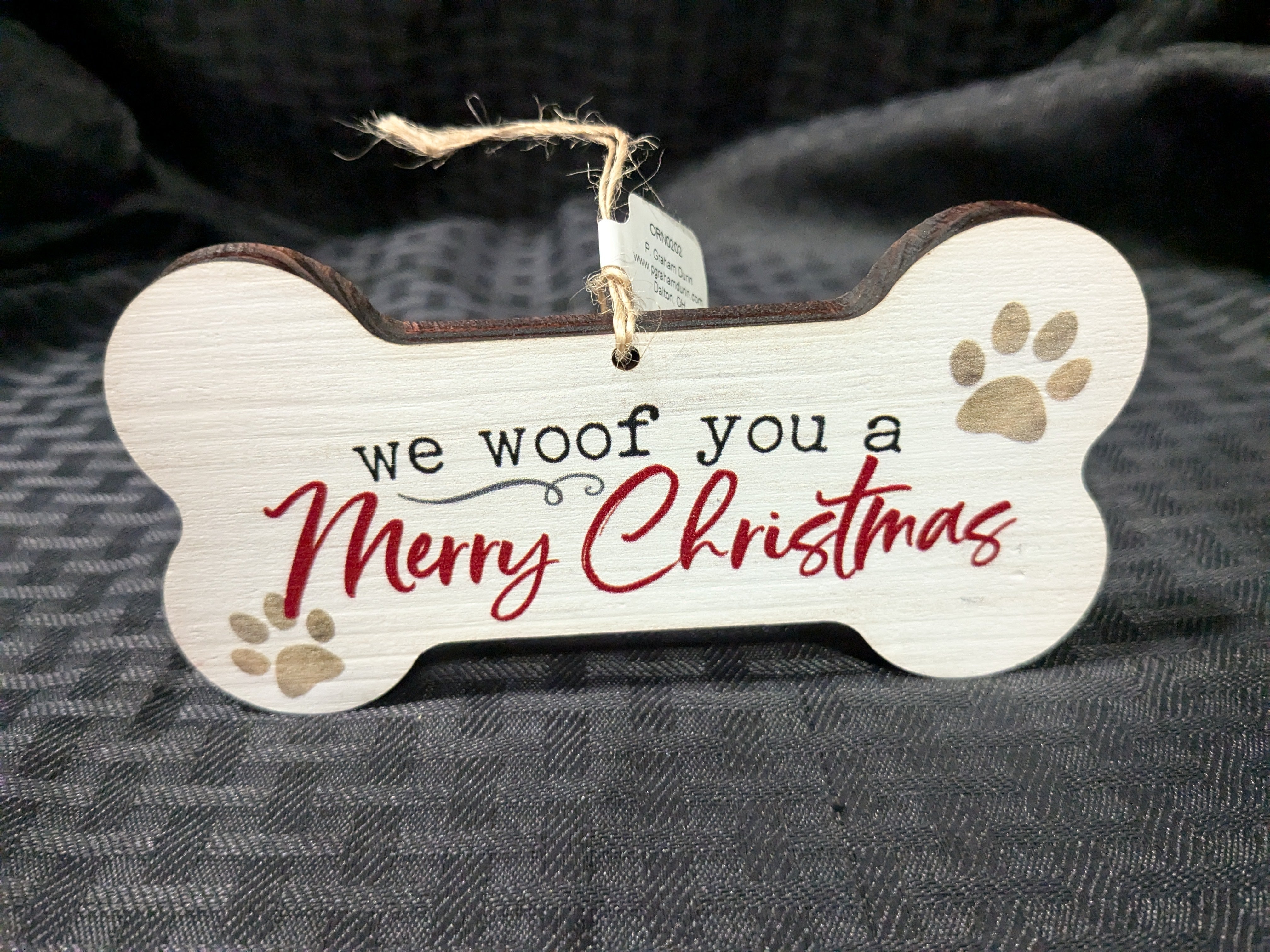 We Woof You a Merry Christmas' painted block – a festive decor piece featuring a playful message perfect for dog lovers. This charming block adds a whimsical touch to your holiday decorations, making it ideal for display on mantels, shelves, or tabletops.