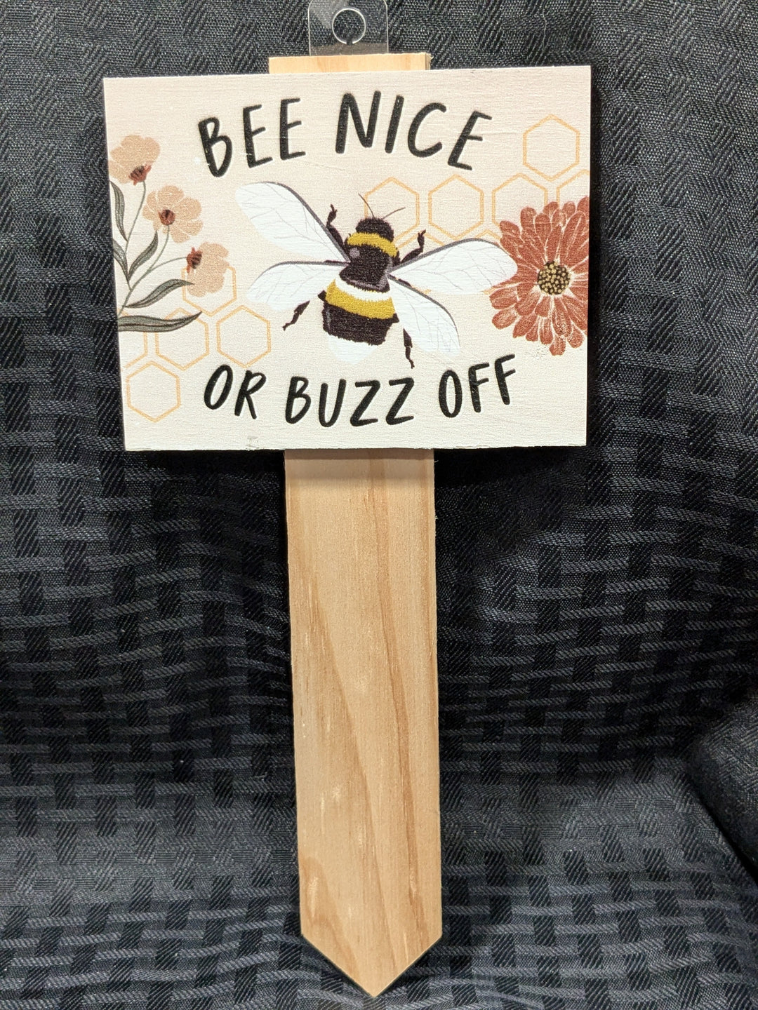 Bee Nice or Buzz Off Garden Stake – a whimsical garden decoration featuring a cheerful bee illustration and playful message, perfect for adding personality to gardens or patios. Made from durable materials for outdoor use.