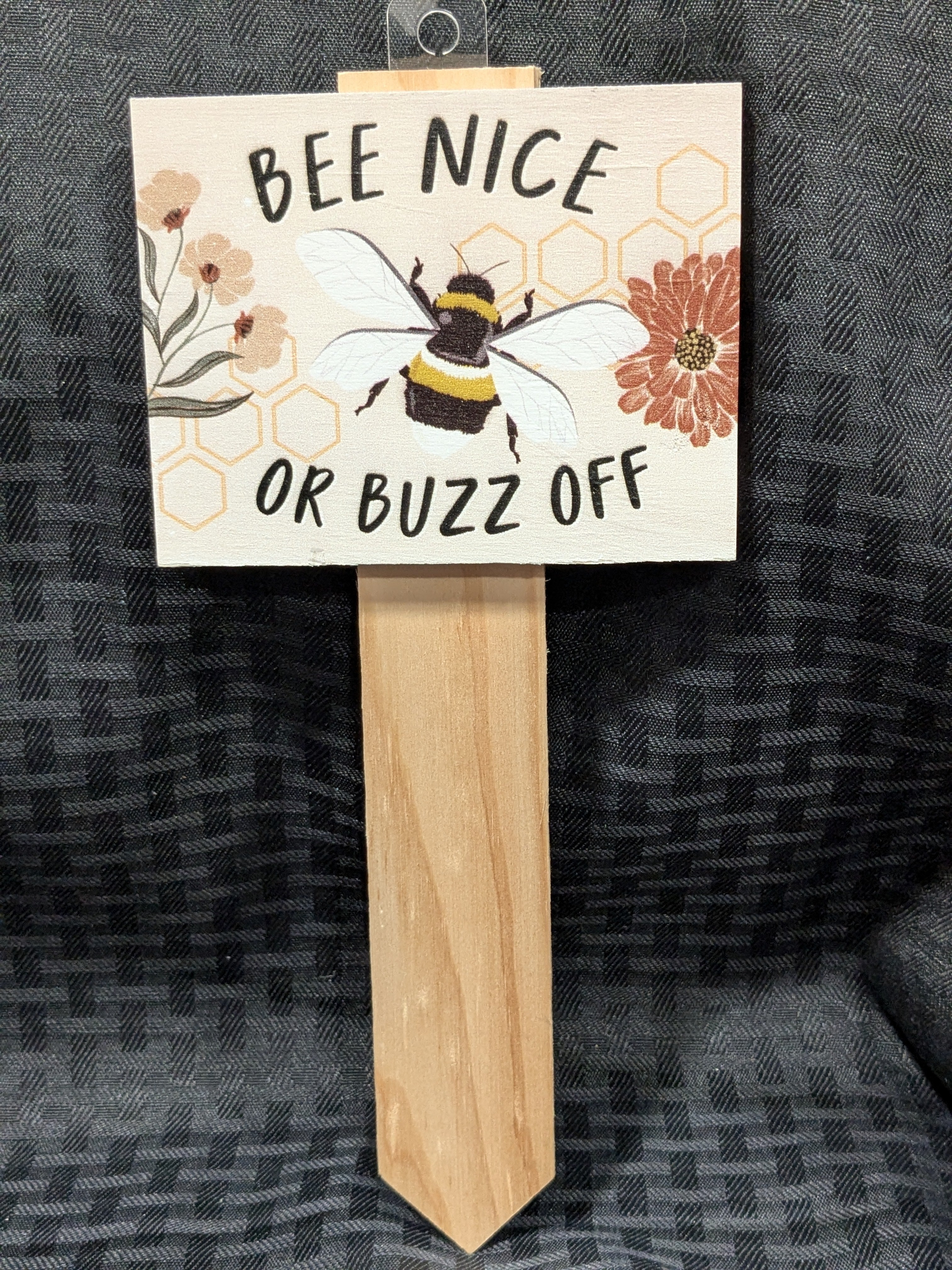 Bee Nice or Buzz Off Garden Stake – a whimsical garden decoration featuring a cheerful bee illustration and playful message, perfect for adding personality to gardens or patios. Made from durable materials for outdoor use.