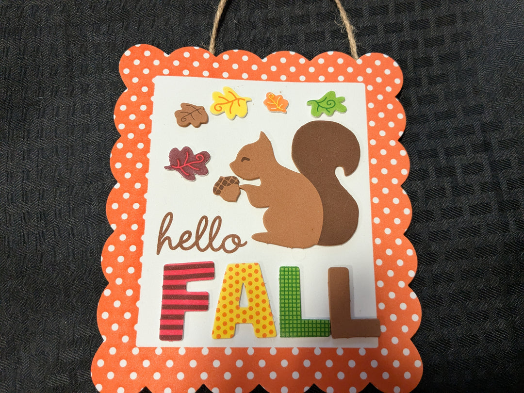 Hello Fall' readymade craft decor block – engraved wood block featuring a stylish white pumpkin and plaid design, complemented by an orange pumpkin. A rustic photo frame perfect for autumn decor, ideal for showcasing family photos or seasonal accents.