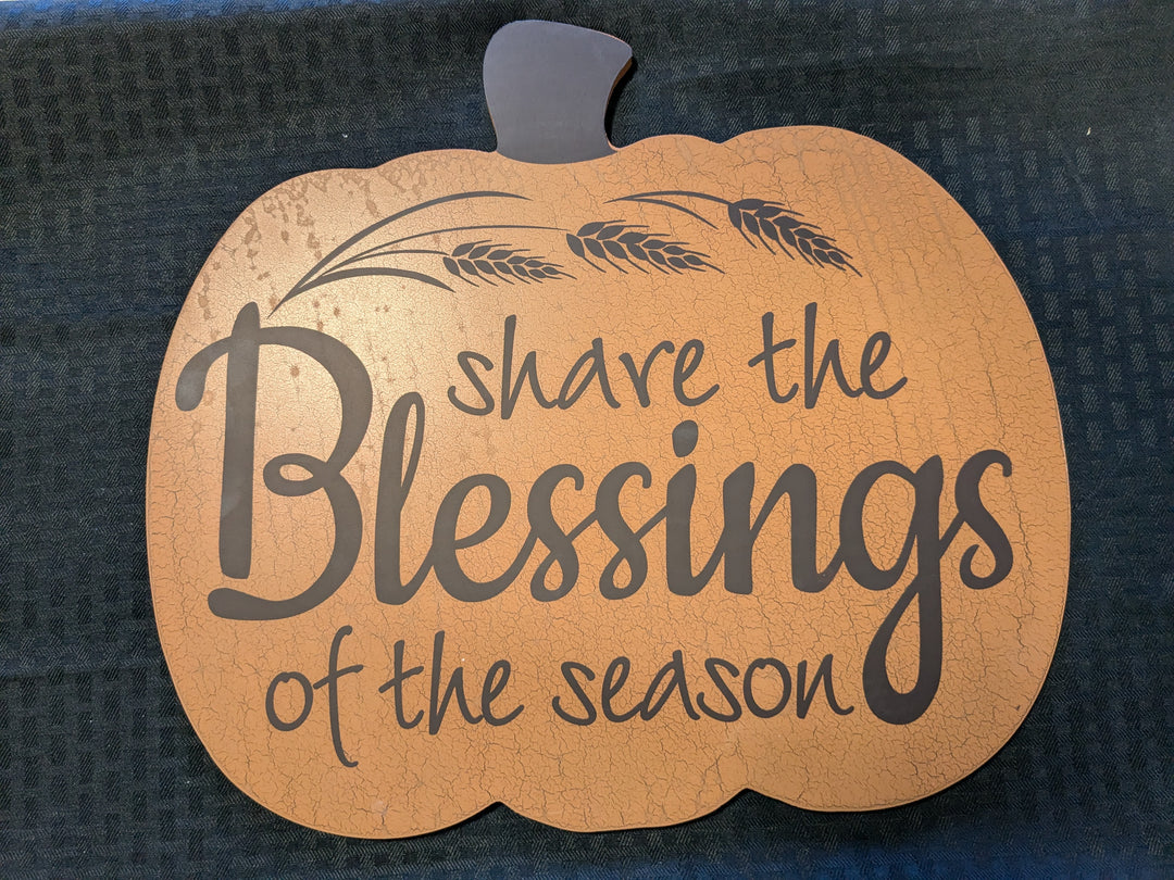 Share the Blessings of the Season' fall sign – a beautifully crafted readymade decor piece featuring an engraved message with white pumpkin and orange pumpkin plaid accents. Perfect for autumn decor, this rustic block adds warmth and charm to any home.